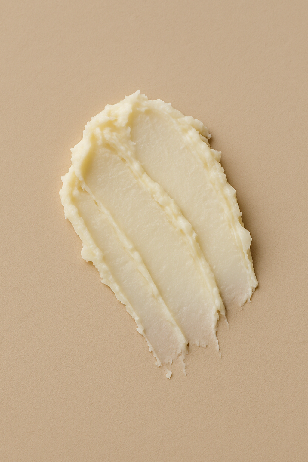 Close-up of smooth shea butter texture gently spread on a natural surface — CARE.ITÉ 100% pure shea butter.